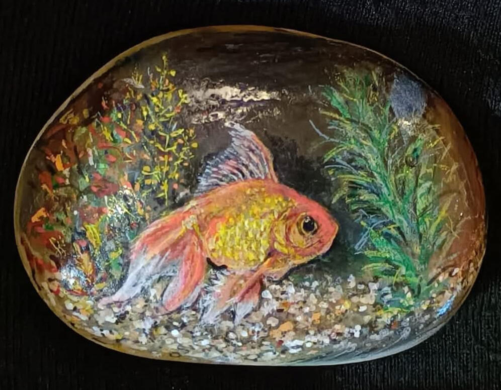 A goldfish hand painted onto a stone by Sue's Stones and Fine Art
